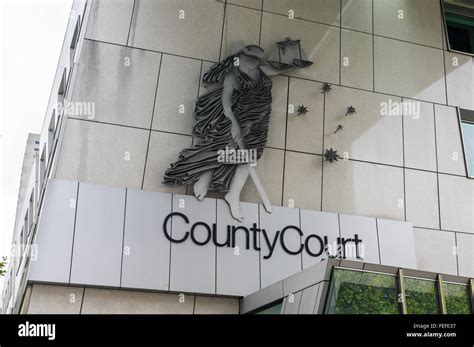 Blindfolded Lady Justice With Sword And Balance On The Wall Of The