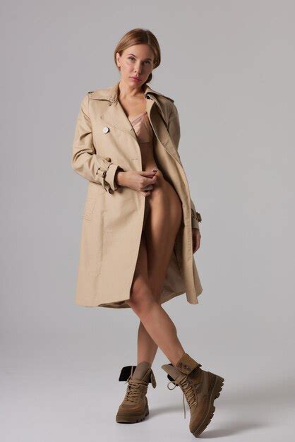 Premium Photo Woman In Trenchcoat And Underwear In Studio