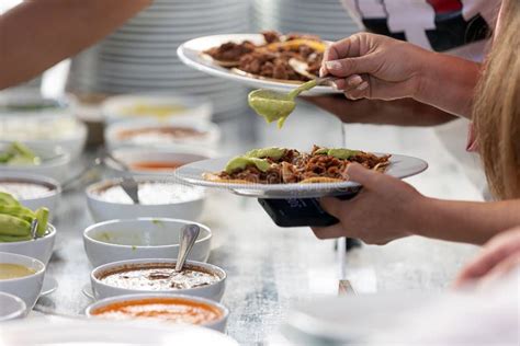 Hand Holding A Plate With Mexican Pastor Tacos In Mexico City Stock