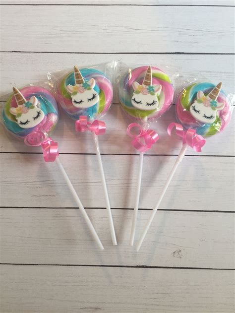 Four Lollipops With Unicorn Faces On Them