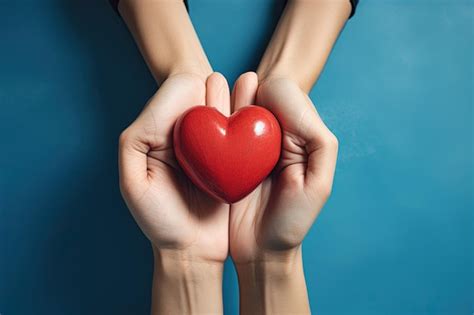 Premium Photo A Person Holding A Red Heart In Their Hands