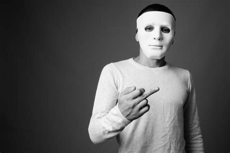 Premium Photo Portrait Of Man Wearing Mask Against Black Background