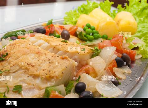 Traditional Portuguese Cod with potatoes, peas and vegetables Stock ...