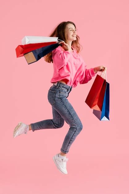 Free Photo Woman With Shopping Bags Jumping