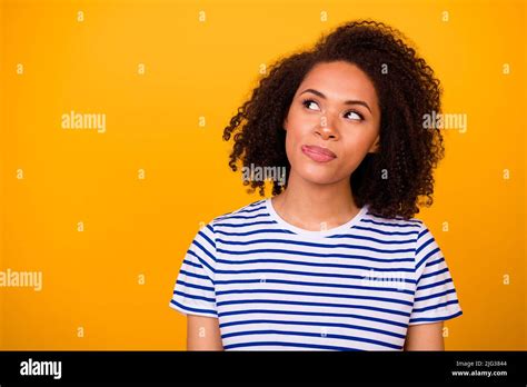 Portrait Of Minded Adorable Girl Tongue Lick Lip Look Interested Empty Space Isolated On Yellow