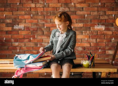 Cute Schoolgirl Puts Textbook Into The Schoolbag Side View Female