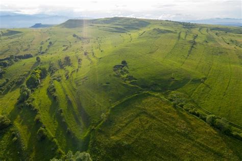 Premium Photo | Aerial view of countryside vibrant green hills ...