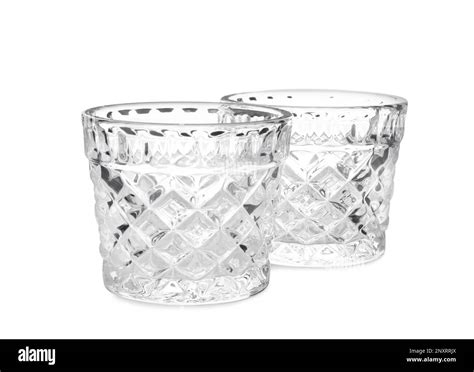 Two modern glass candle holders on white background Stock Photo - Alamy