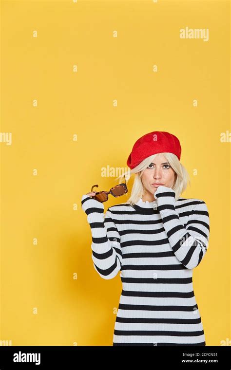 Cheerful Blonde Woman In Striped Blouse And Red French Cap Smiling On