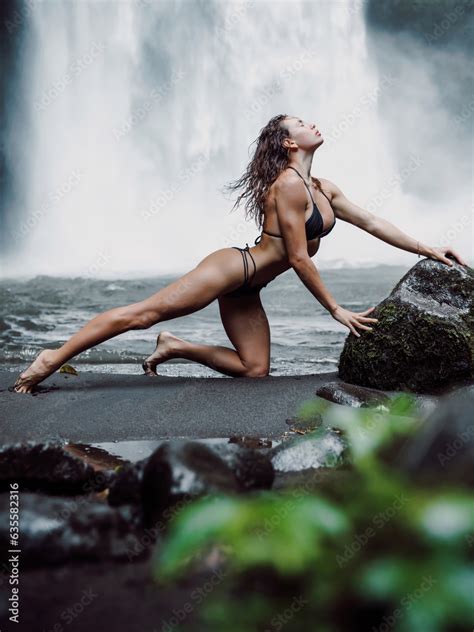 Gorgeous Woman In Bikini Near Waterfall In Tropical Bali Traveler Girl Posing On River With