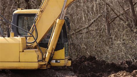 Working Backhoe By Digging Ground At Construction Site Excavator