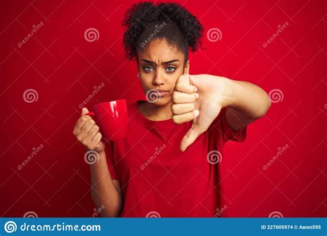 Young African American Woman Drinking A Cup Of Coffee Over Isolated Red