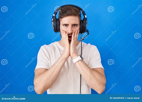 Hispanic Man With Beard Listening To Music Wearing Headphones Afraid