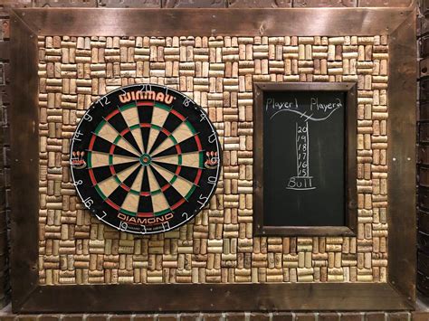 a wooden frame with a dart and darts on it