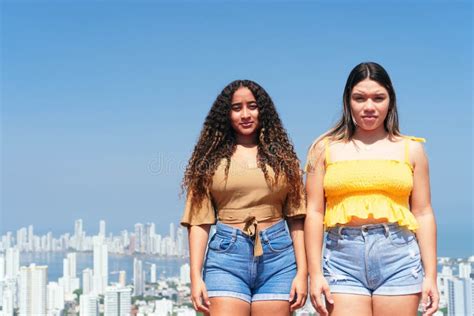 Two Casually Dressed Latina Friends Hanging Out Together In The City Stock Image Image Of