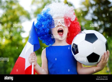 Funny little girl supporting and cheering her national football team ...