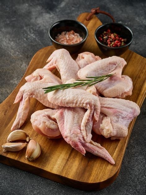 Premium Photo Uncooked Chicken Wings With Pepper And Salt On Wooden