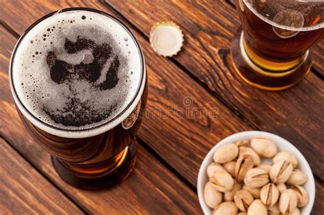 Vidro Da Cerveja Espumoso Fria Escura Tabela De Madeira Velha Nuts