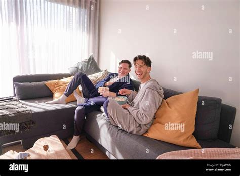 Happy Gay Couple Relaxing On Sofa Stock Photo Alamy
