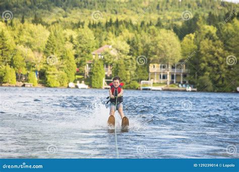 Child Learning To Water Skiing On A Lake Stock Photo Image Of Jacket