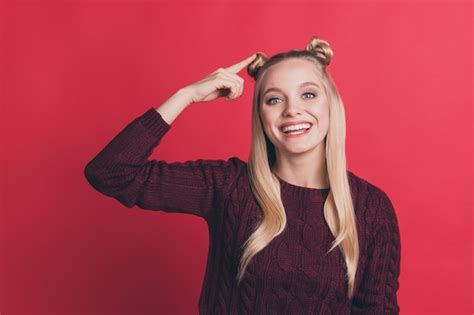 Premium Photo Blonde Woman With Top Knots Posing Against The Red Wall