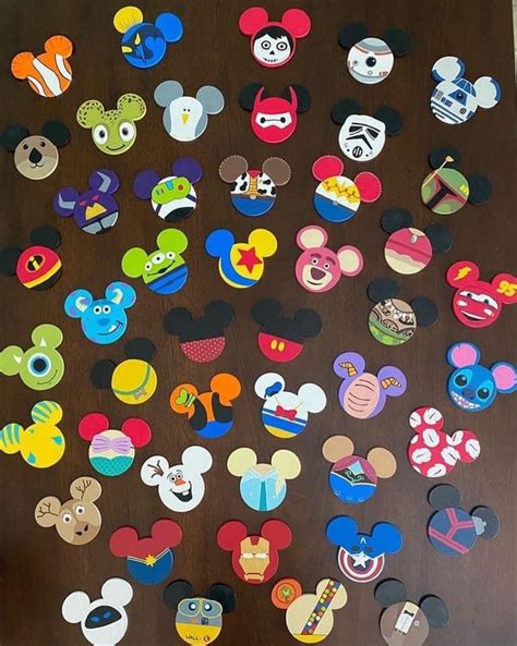 mickey mouse magnets are arranged on a wooden surface with the faces of many different disney ...