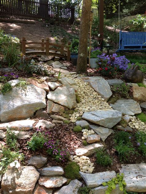 A dry creek bed.... | Front yard landscaping, House landscape, Rock garden