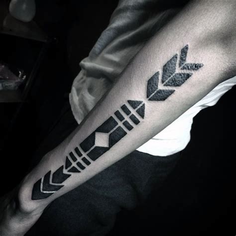 Tribal style black and white arrow shaped tattoo on forearm - Tattooimages.biz