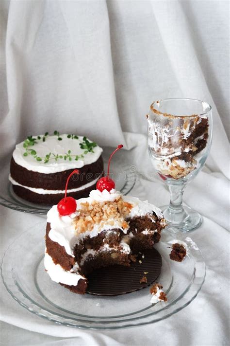 Chocolate Naked Cake With Cream Frosting And Decorated With Cherry Peanut And Thyme Stock Photo