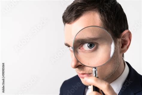 Young Man Holding A Magnifying Glass Stock Photo Adobe Stock