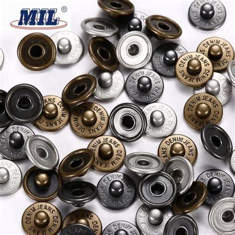 many different types of metal buttons on a white surface with m & l ...