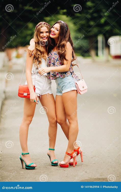 Two Stylish Blonde And Brunette Having Fun Together Stock Photo Image Of Shorts Hand 141963994