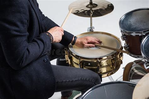 Close Up Of Hands Of Male Drummer Holdning Drumsticks Sitting And