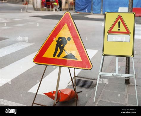 Different traffic signs near pedestrian crossing on city street Stock ...