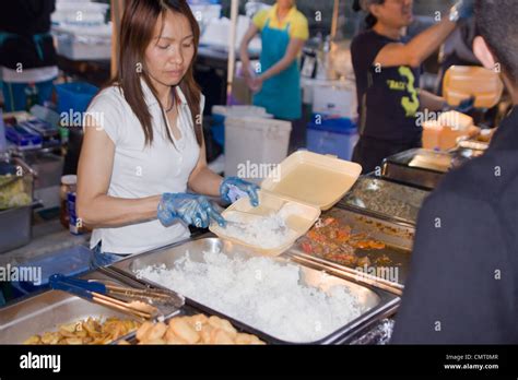 A woman serving Caribbean street food at the Notting Hill Carnival ...