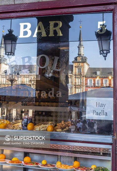 The Plaza Mayor Reflected in the window of a cerveceria and Tapas bar ...