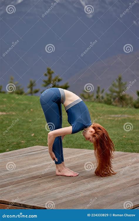 Side View Beautiful Redhead Yoga Woman In Leggings And Sport Top Is Practicing Yoga Exercises