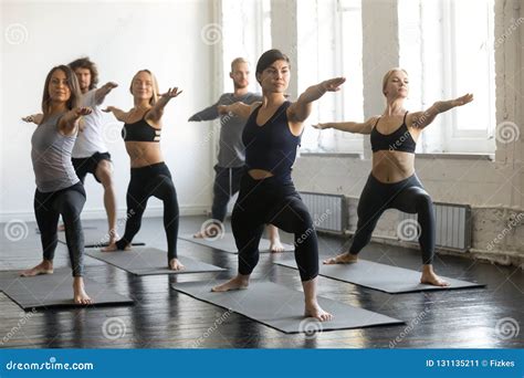 Group Of Young Sporty People In Warrior Ii Exercise Stock Image Image