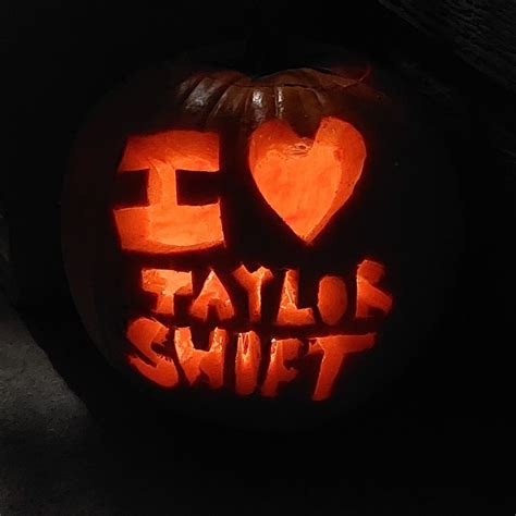 a carved pumpkin with the words i love taylor swift carved into it