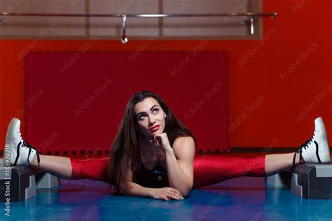 Young Attractive Muscular Woman Stretching Legs On Step Platforms Stock