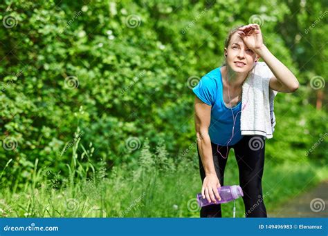 Tired Woman Runner Having Rest After Running Road In Forest Bending