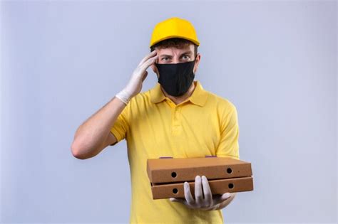 Free Photo Delivery Man In Yellow Polo Shirt And Cap Wearing Black