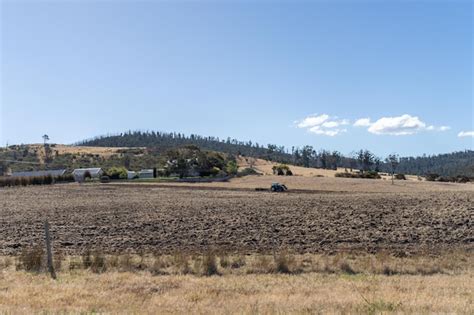 Premium Photo Tractor Plowing A Field In A Dry Hot Summer Farming Landscape Australia