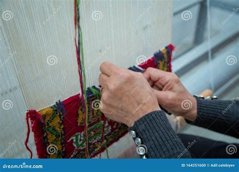 Weaving And Manufacturing Of Handmade Carpets Closeup Women`s Hands