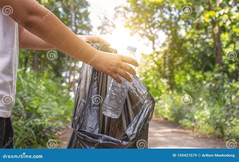 The Person `s Hand Collects Plastic Bottles For Recycling Stock Image