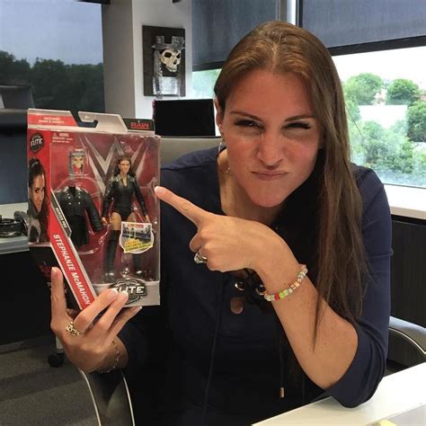 a woman sitting at a desk holding up a box with an image of the x - men ...