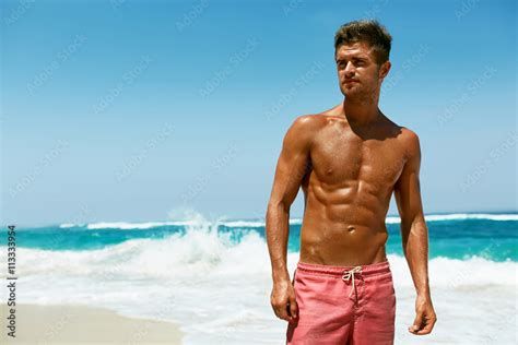 Sexy Man On Beach In Summer Handsome Male With Fit Body Healthy Skin Sun Tan Tanning Near Sea