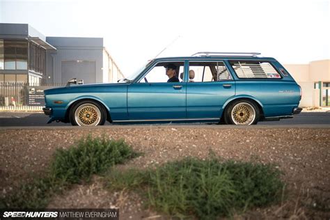 A Blue Station Wagon Parked In Front Of A Building