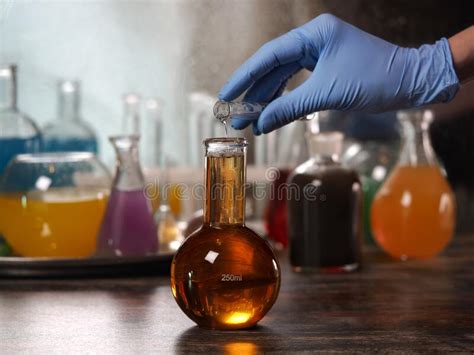 Glassware With Colorful Liquid And Dry Ice On The Table Stock Photo