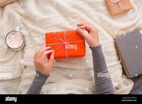 Woman Drinking Hot Cocoa And Opening Presents Stock Photo Alamy
